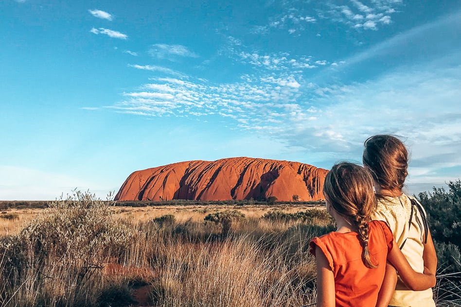 Sunset by Uluru or Ayers Rock with kids in the Outback of Australia