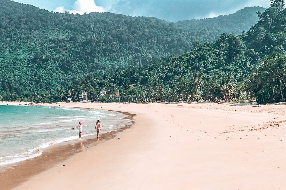 Kids walking on a beach in Tioman, Malaysia, perfect for family travel on a budget
