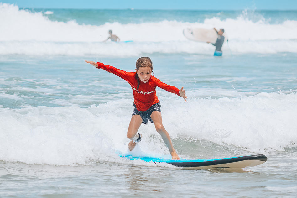 Kid Standing Up First Time Surfing Lesson Go Ride A Wave