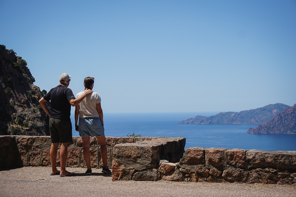 Couple looking out from the road to the Calanques de Piana in Corsica.