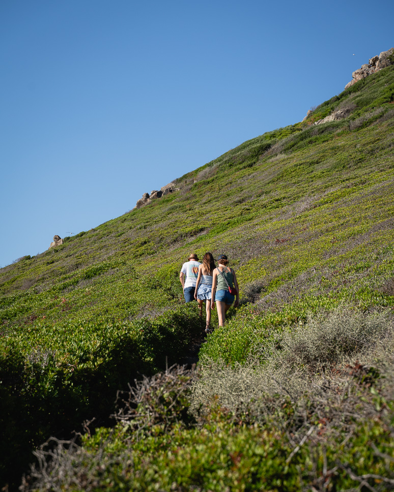 Family on the walking path at Pointe de la Parata in Corsica