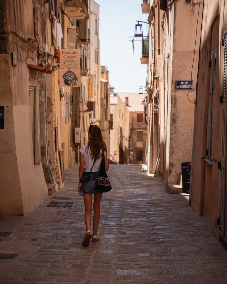 Girl walking through the narrow streets of the old town within the citadel of Bonifacio.