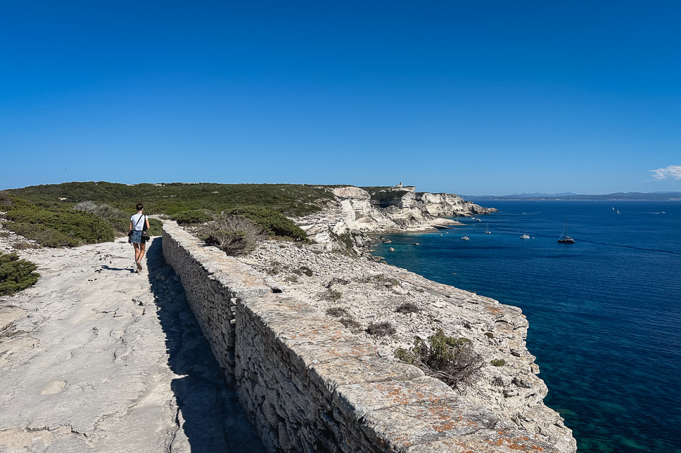Girl walking on the path along the cliffs of Bonifacio in Corsica.